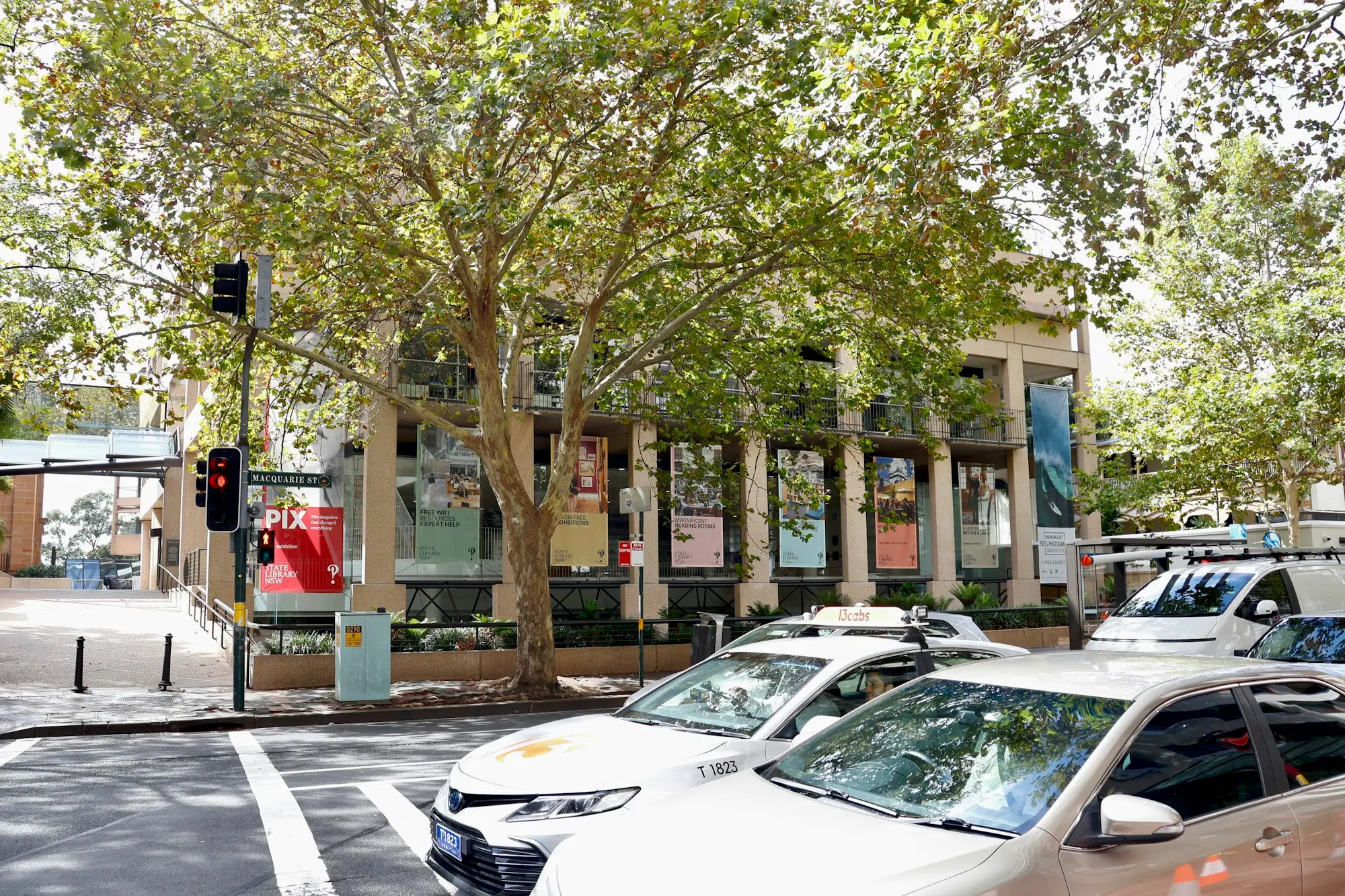 Main street of a New South Wales coastal town with shopfronts and cars parked on the left