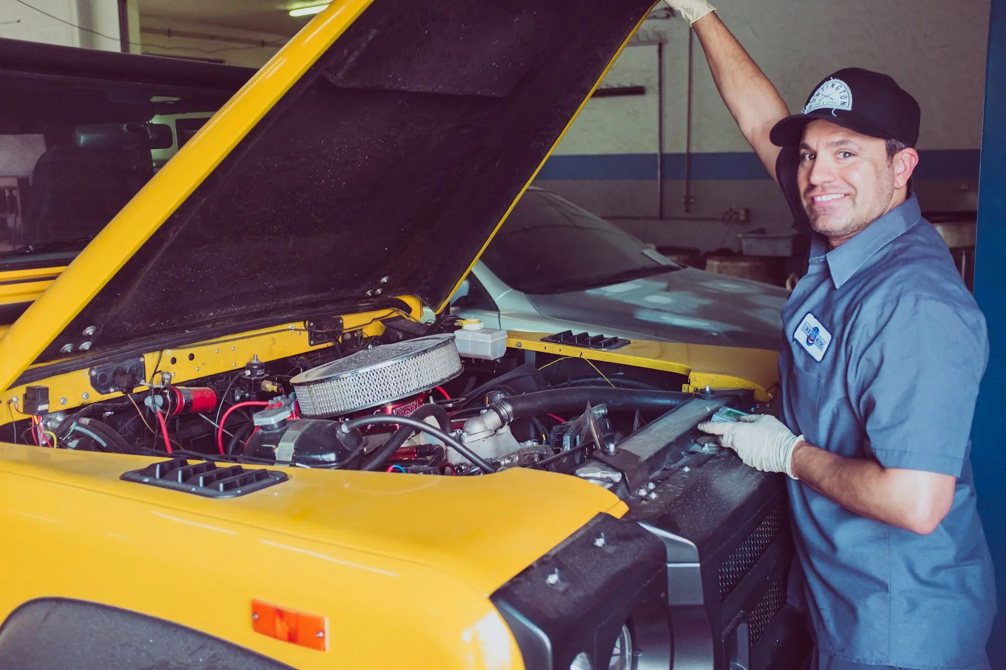 Mechanic working under a raised ute in a regional Victorian workshop